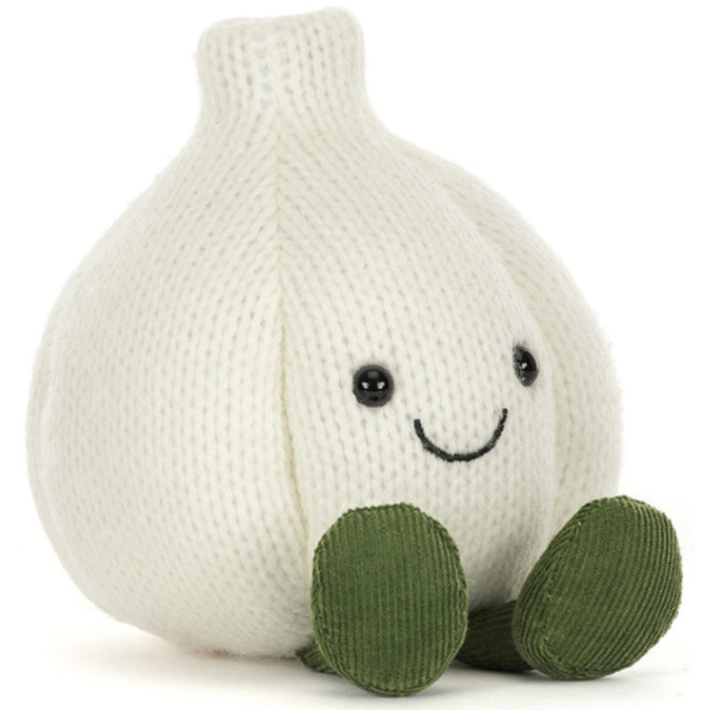 A knitted garlic plush toy in off-white with green feet and a simple embroidered smiley face, photographed on a clean white background.