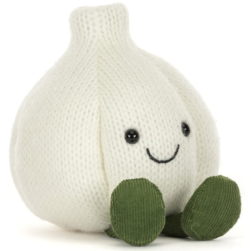 A knitted garlic plush toy in off-white with green feet and a simple embroidered smiley face, photographed on a clean white background.