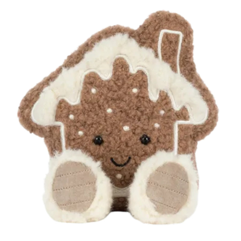 A cute gingerbread house plush toy with a brown textured body, white icing details, and a smiling face, isolated on a white background.