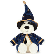 Jellycat's Rufferty dog plush dressed as a wizard, wearing a navy blue pointed hat and matching robe with gold star patterns and trim, set against a plain white background.