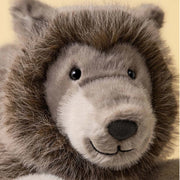 Ulrich Wolf from Jellycat is looking relaxed.  He's got black eyes and a bit of a mane around his face with a pleasant smile. 