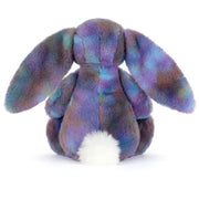 A plush bunny toy photographed from the back on a clean white background. The bunny has a fuzzy, iridescent purple and blue body with a white fluffy tail.