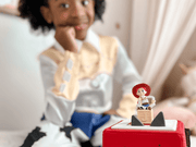 Tonie Disney Toy Story Jessie figure on red Toniebox with child playing in background