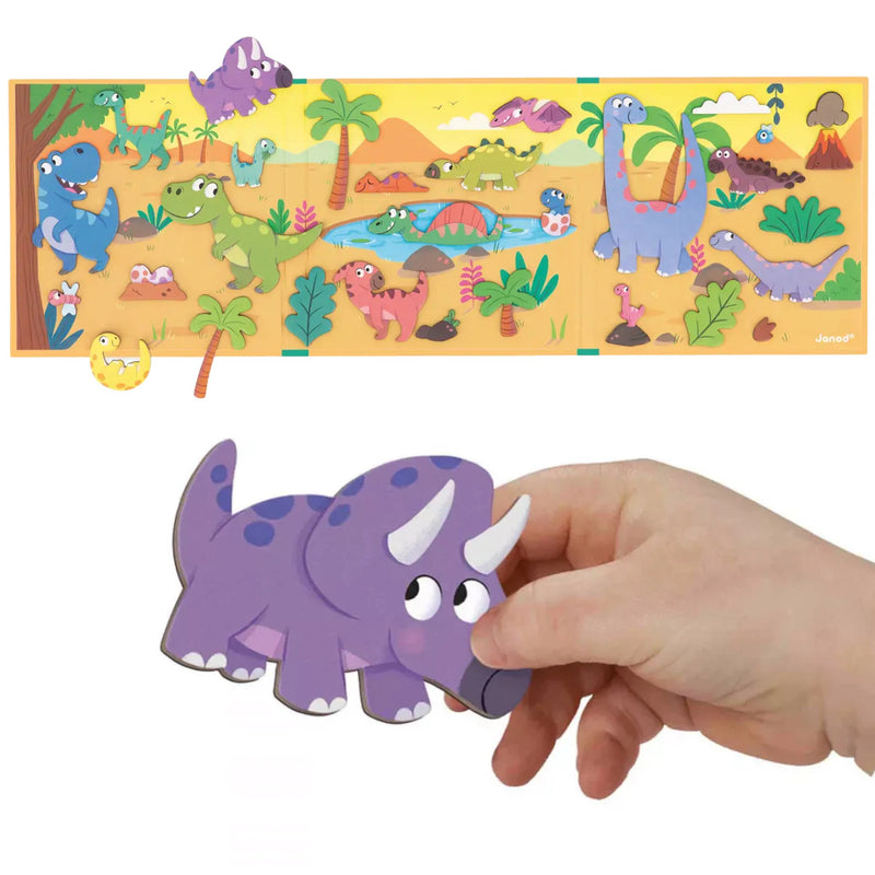A children's dinosaur puzzle board with colorful cartoon dinosaurs and a purple dinosaur toy being held by a human hand, shown on a white background.