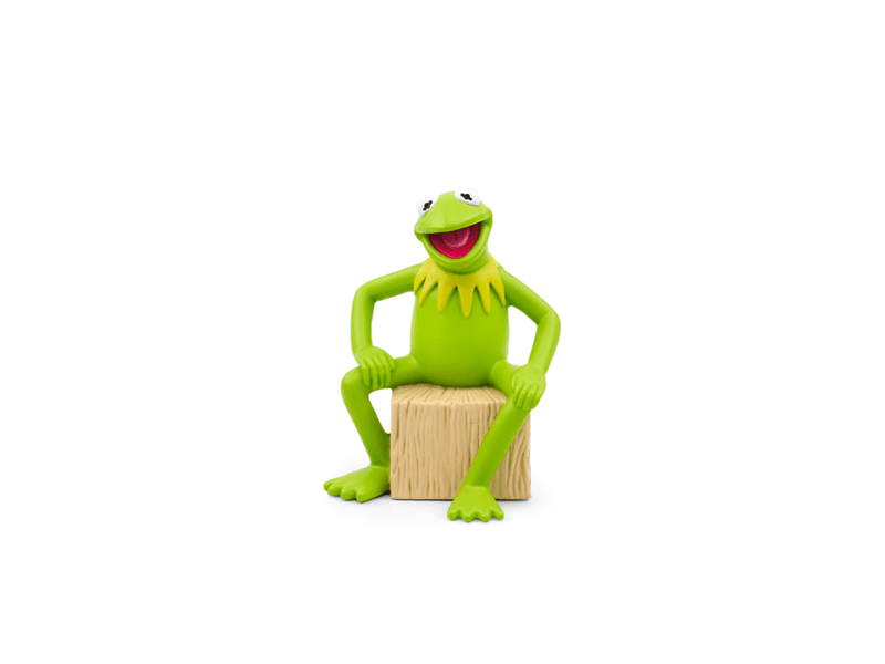 Green Kermit the Frog Tonie figure sitting on wooden log against white background