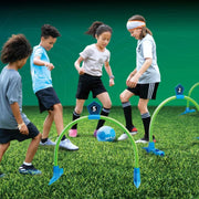 Four children playing Kick Croquet Strike game with green arches and blue soccer ball on grass