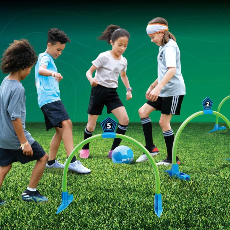 Four children playing Kick Croquet Strike game with green arches and blue soccer ball on grass