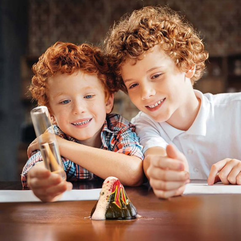Two children playing with the KidzLab pocket volcano on a table.
