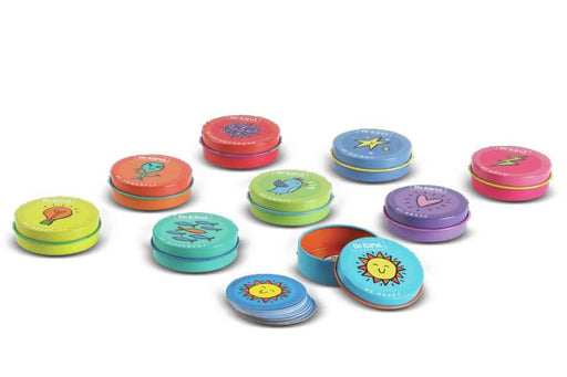 Colorful round Be Kind tin containers with various motivational icons and designs