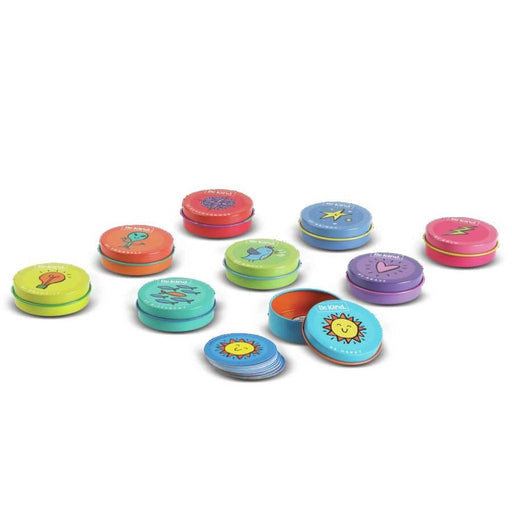 Colorful round Be Kind tin containers with various motivational icons and designs