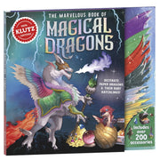 The Marvelous Book of Magical Dragons book cover shown at an angle, featuring a white dragon with colorful wings and a small red dragon hatching from an egg. The cover includes a red Klutz Certified seal and text about including over 200 accessories.