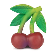Red cherry teething toy with green leaves and stems on white background