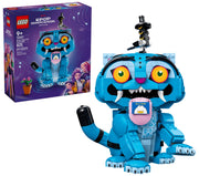 LEGO K-POP Dragon Warrior set 42422 building toy shown with its retail box on a white background. The assembled toy is a blue dragon character with large orange eyes, white fangs, a pink belly screen, and a small black-and-white bird figure on top.