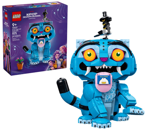 LEGO K-POP Dragon Warrior set 42422 building toy shown with its retail box on a white background. The assembled toy is a blue dragon character with large orange eyes, white fangs, a pink belly screen, and a small black-and-white bird figure on top.