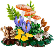 LEGO's Woodland Mushroom building set on a white background, featuring orange and white spotted mushrooms, purple flowers, yellow mushrooms, green foliage, brown tree stumps, and small white flowers.