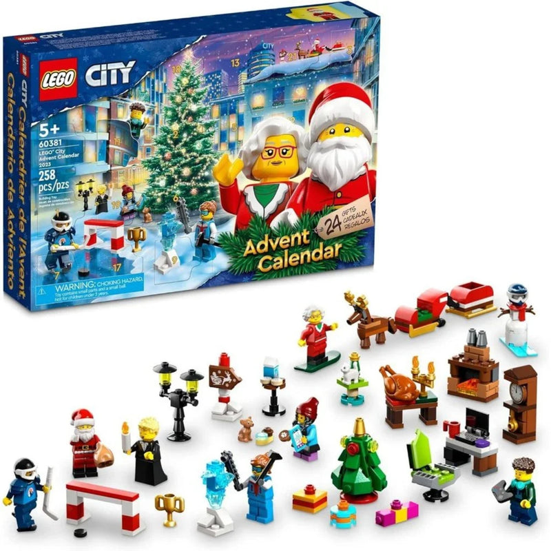LEGO City Advent Calendar set shown with its illustrated box and many small holiday-themed building pieces and minifigures arranged in front on a white background.