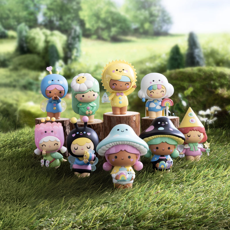 Colorful Momiji Magical Meadow blind box figures displayed on wooden logs in grassy outdoor setting