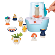 Kids pottery wheel kit with various small ceramic figures around it on a white background
