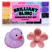 Brilliant Bling Bedazzle DIY Kit by Mavi Bandz, featuring a clear plastic tray of 24 colorful iridescent rhinestones and two finished DIY embellishment samples: a purple rhinestone-covered duck and a pink rhinestone-covered flower.