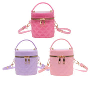 Three quilted cylindrical handbag charms in pink, purple, and light pink, each with a top handle, zippered front, and detachable shoulder strap, shown on a plain white background.