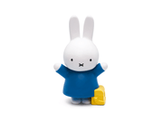 White Miffy bunny character figurine wearing blue dress with yellow suitcase on white background