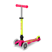 Micro Kickboard Mini Deluxe Foldable LED scooter in neon pink and yellow-green with light-up wheels