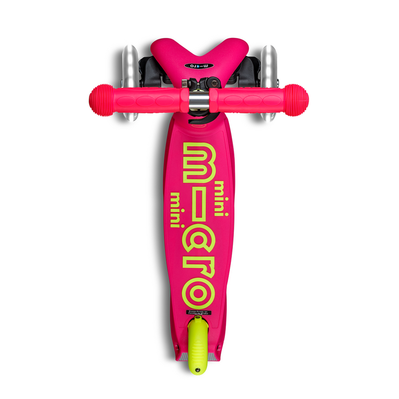 Mini Micro Deluxe Foldable LED scooter in neon flamingo pink with yellow-green branding, top-down view