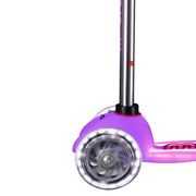 Close-up of a pink Mini Glow Plus LED  Scooter with a lighted base on a white background