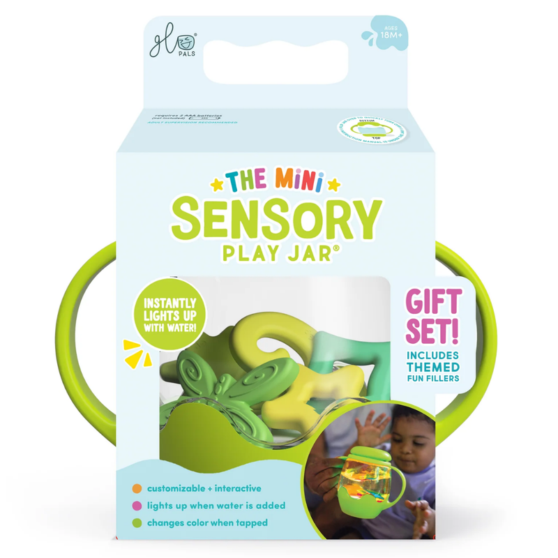Package for the green Glo Pals Mini Sensory Jarwith green handles on a white background.