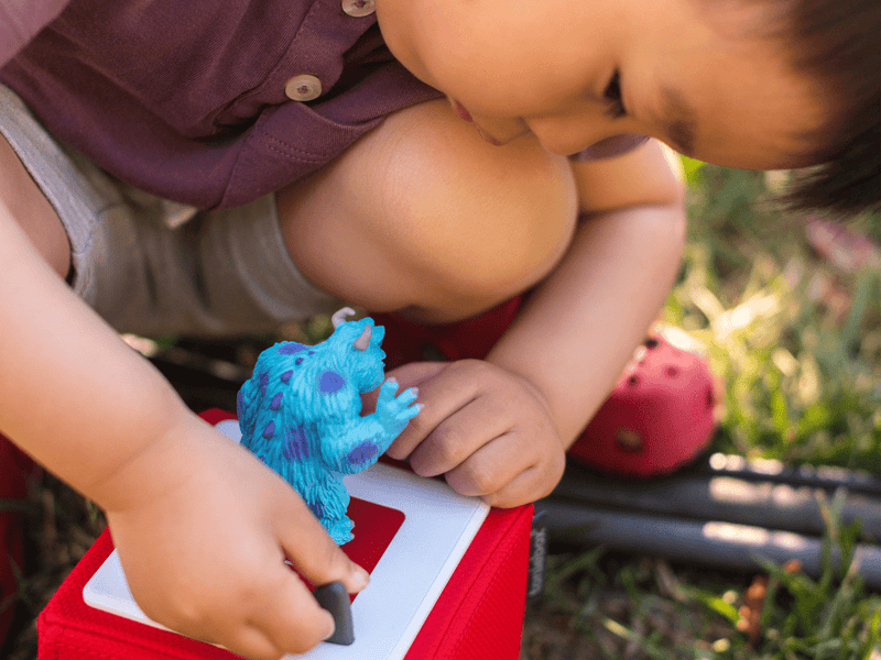 Child holding blue Sulley Tonie figure from Disney Monsters Inc collection