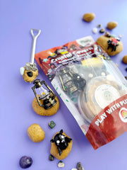 Crystal Cavern play dough kit with mining tools and mineral-themed accessories on purple background