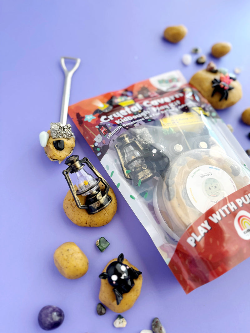 Crystal Cavern play dough kit with mining tools and mineral-themed accessories on purple background