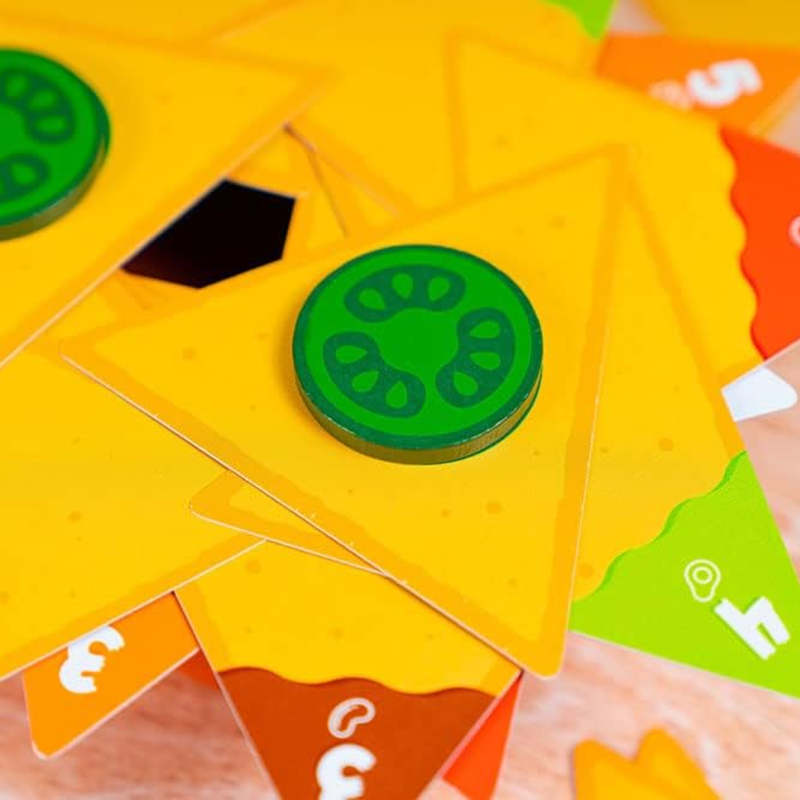 Close-up of colorful card game pieces with a green pepper chip on a yellow tortilla chip card.