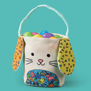 Fabric bunny easter basket with colorful ears and decorative belly panel filled with plastic eggs