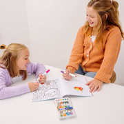 Two girls coloring with OOLY Double Up! Double Ended Markers on white table