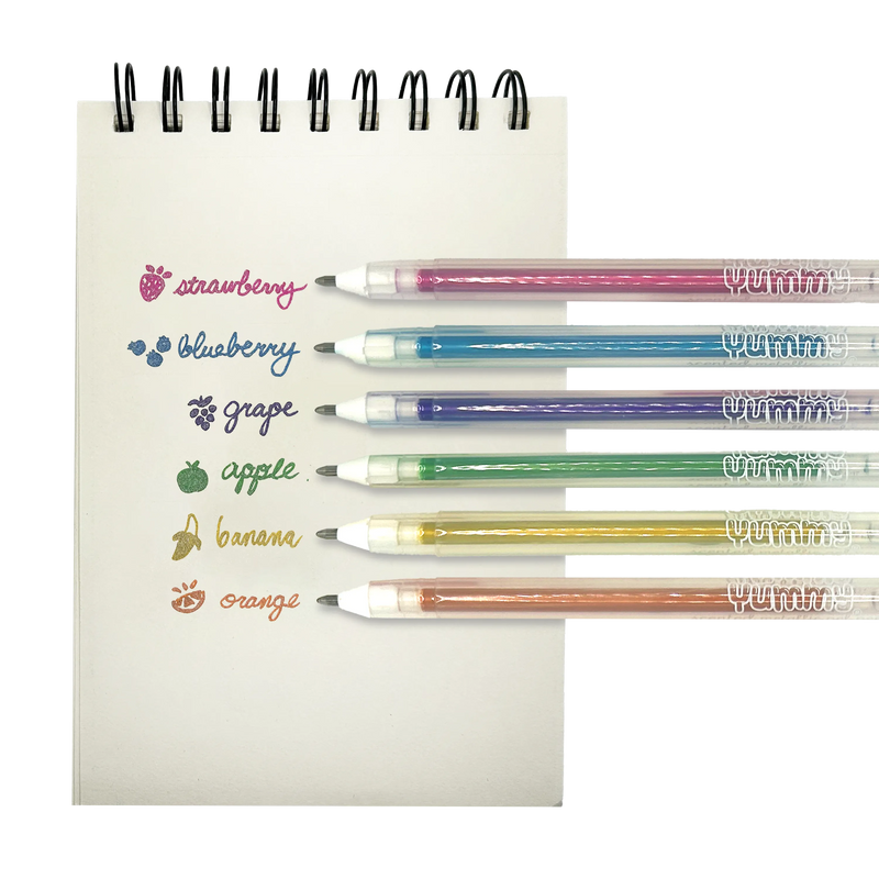 Six colorful scented gel pens with fruit names and corresponding colored ink displayed on notepad