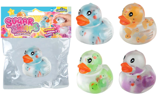 Four translucent rubber duck squishies with colorful pastel fillings and orange beaks, shown next to their retail packaging. The packaging features a colorful header card with the brand name 'Sugar Swaps' and shows one of the ducks inside a clear bag.