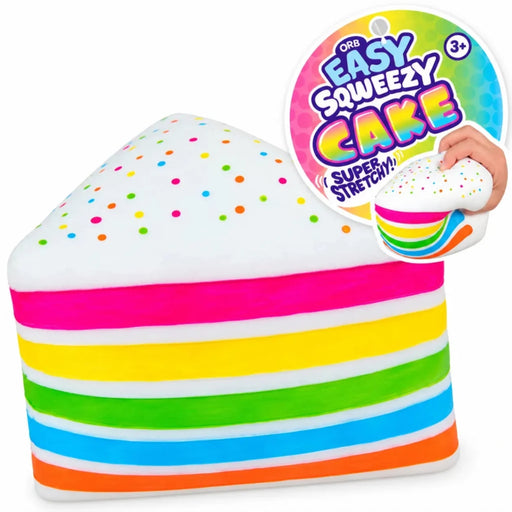 A rainbow-striped cake slice squishy toy with a white frosting top speckled with colorful dots, shown on a white background with a circular product tag and a hand demonstrating the stretch.