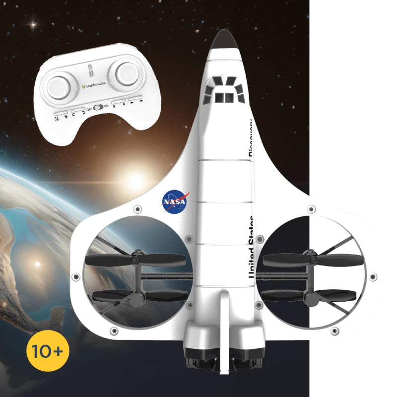 A white toy space shuttle drone with two propellers inside circular frames, shown with a white remote control. The background is a starry space scene with Earth visible on the left.