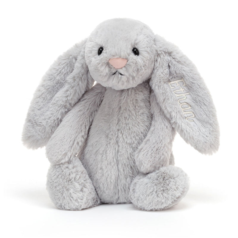 Gray plush bunny stuffed animal with long ears sitting upright on white background