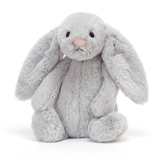 Gray plush bunny stuffed animal with long ears sitting upright on white background