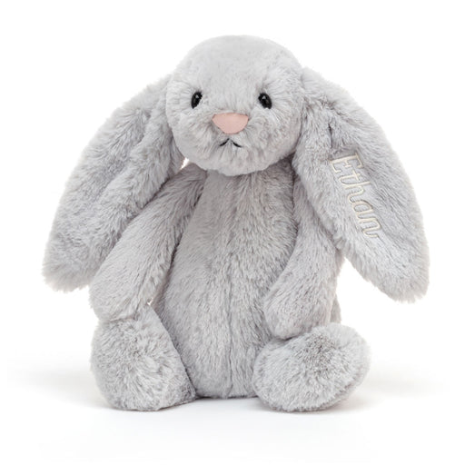 Gray plush bunny stuffed animal with long ears sitting upright on white background