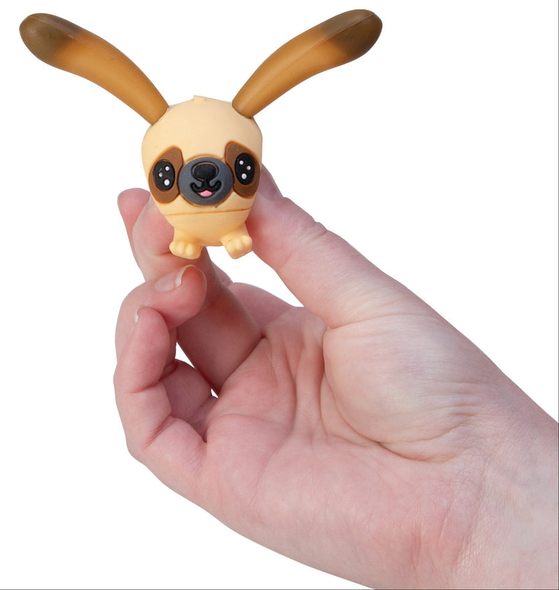 Small tan and brown dog-eared Perk-Ups toy figure held in a human hand