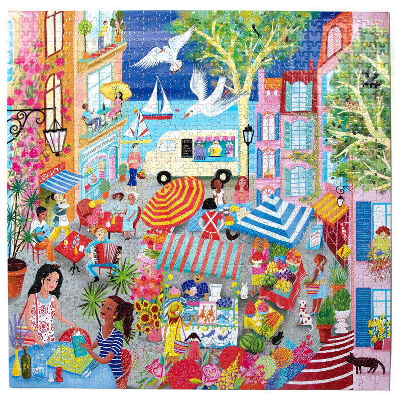 Completed 1000-piece jigsaw puzzle showing vibrant French marketplace scene with people shopping