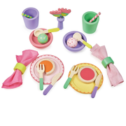 Colorful toy dining set with plates, cups, utensils, and napkins on a white background