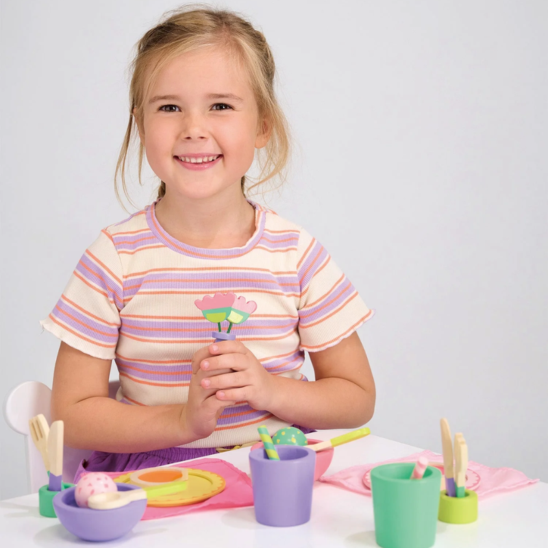 Young girl playing with Menarti Party Time Lunch Set.  Bright, happy colors.