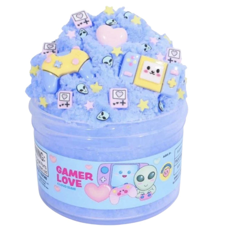 Jar of blue cloud slime by Peachybbies with different types of gamer pieces in it on a white background.