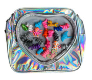 Holographic heart-shaped bag open revealing colorful collectible toys inside