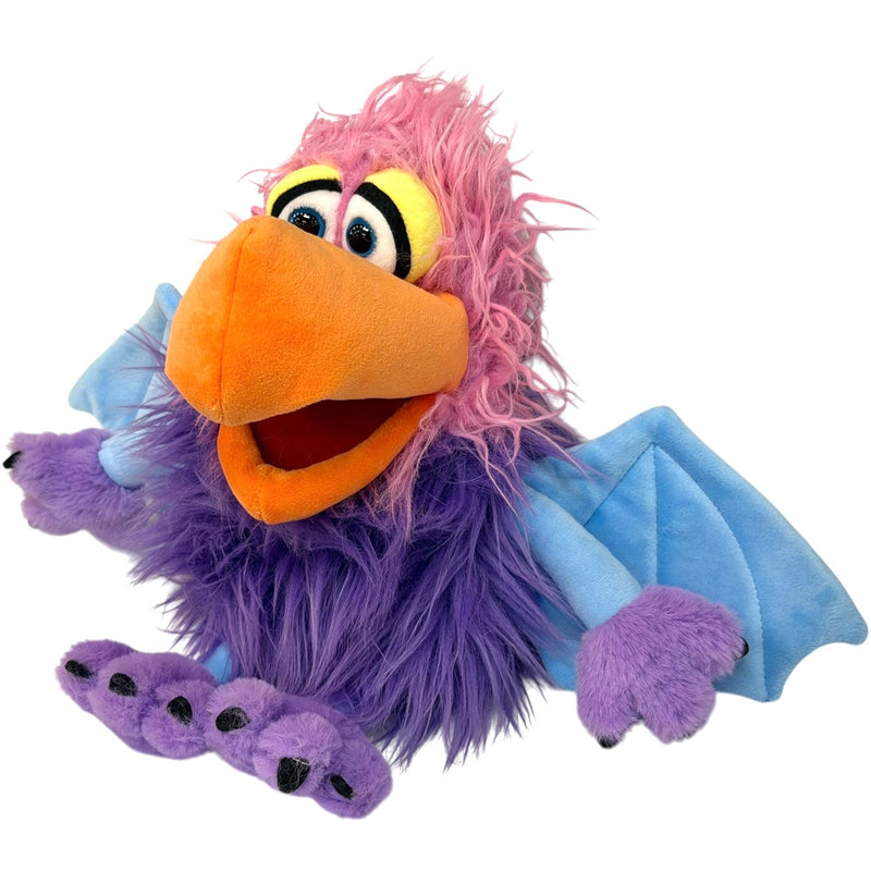 Purple furry puppet with pink hair, orange beak, and blue wings on white background