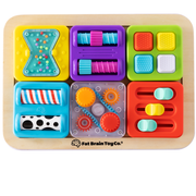 Colorful puzzle toy with various shapes and textures on a wooden base, branded as Fat Brain Toy Co.